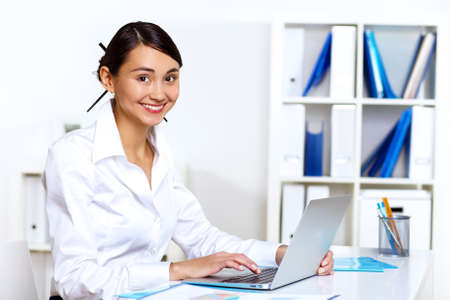 Portrait of young woman in business wear in officeの写真素材