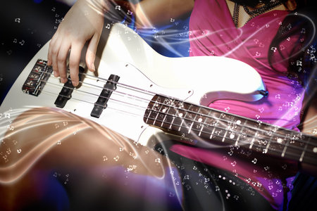 Young guitar player with instrument performing in night club
