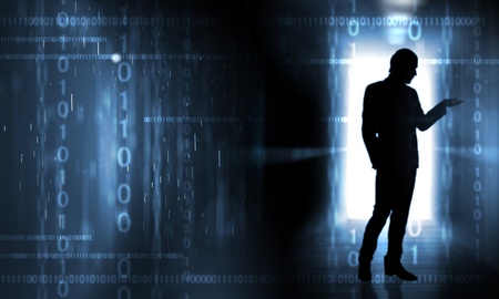 Silouhette of a person against digital backgroundの写真素材