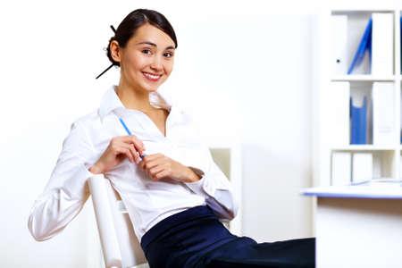 Portrait of young woman in business wear in officeの写真素材