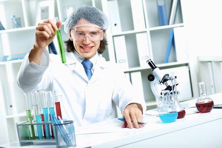 Young scientist in white uniform working in laboratoryの写真素材