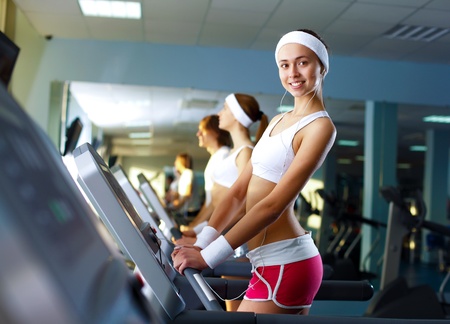 Young woman in sport wear doing sport in gymの写真素材