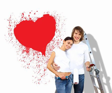 Young caucausian couple with paint brushes togetherの写真素材