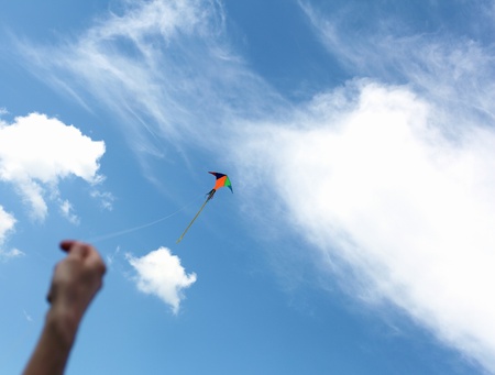 wind kite flying in the blue summer skyの写真素材