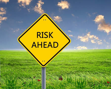 Picture of yellow road sign warning about risk aheadの写真素材