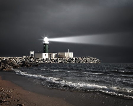 Image of a lighthouse with a strong beam of lightの写真素材