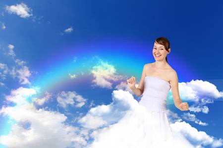 Image of young woman against blue sky backgroundの写真素材