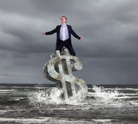 Businessman in suit praying for success in businessの写真素材