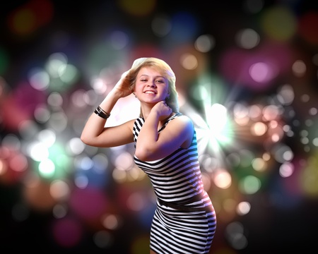 Image of young woman and colorful disco backgroundの写真素材