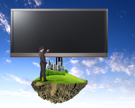 Business person standing near a blank  billboardの写真素材