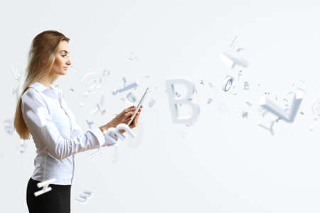 Young woman in business wear with touchscreen technology backgroundの写真素材