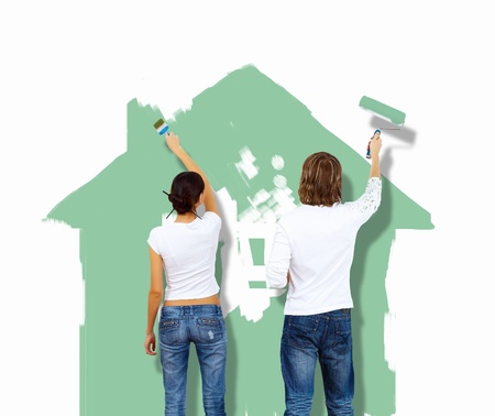 Young caucausian couple with paint brushes togetherの写真素材