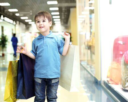 Little boy in blue shirt doing shoppingの写真素材