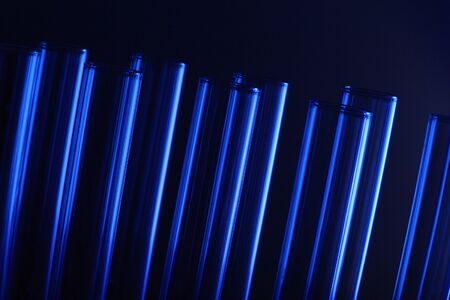 Glass chemistry tubes on a colour backgroundの写真素材