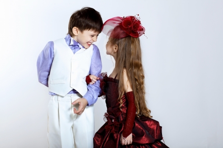 Portrait of a little boy and girl in beautiful dressの写真素材
