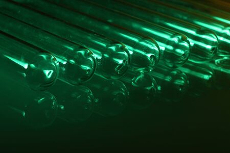 Glass chemistry tubes on a colour backgroundの写真素材