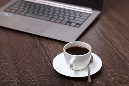 White cup with black coffee at business workplaceの写真素材