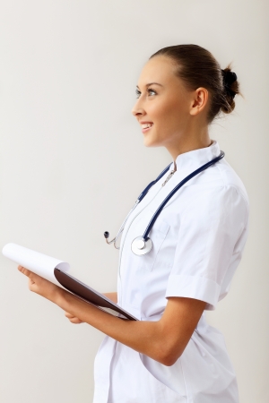 Young female doctor in white uniform at workplaceの写真素材