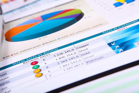 Financial paper charts and graphs on the table