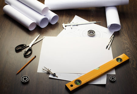 Tools and papers with sketches on the table