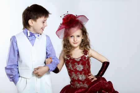Portrait of a little boy and girl in beautiful dressの写真素材