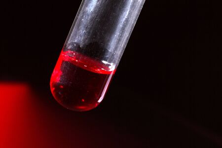 Glass chemistry tubes on a colour backgroundの写真素材