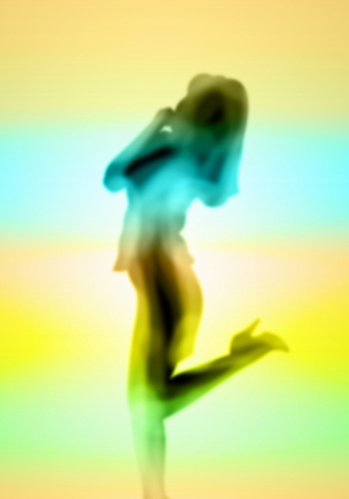Image with a blurred female silhouette against colour backgroundの写真素材