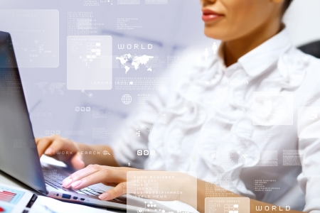 Business person working on computer against technology backgroundの写真素材