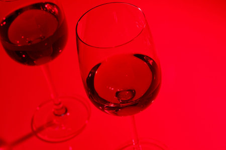 Glasses with wine on the color backgroundの写真素材