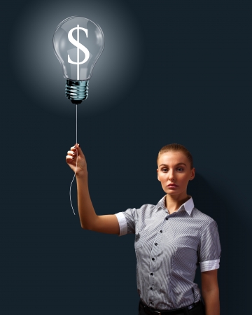 Light bulb and a business person as symbols of creativity in businessの写真素材