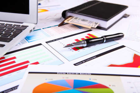 Financial paper charts and graphs on the tableの写真素材