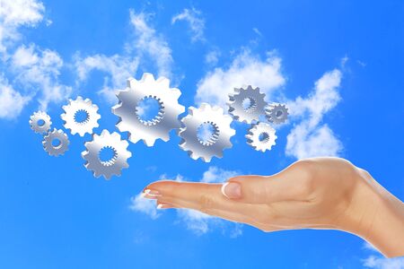 Image with machinery gears and human handの写真素材