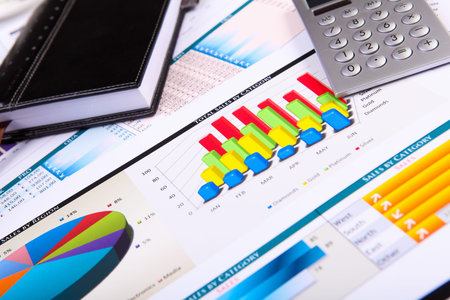 Financial paper charts and graphs on the table
