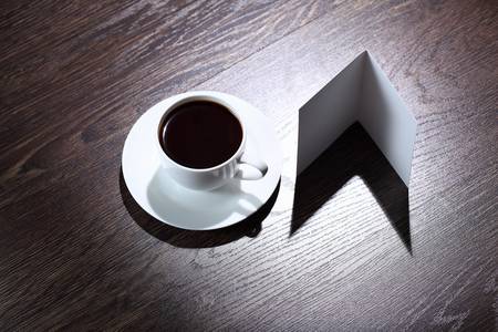 White cup with black coffee at business workplaceの写真素材