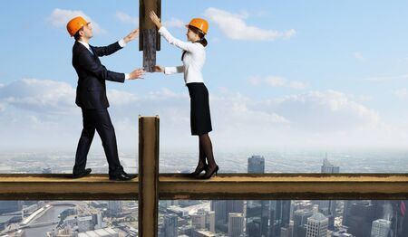 Business man standing high over a cityscape の写真素材