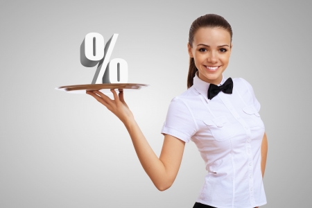 Waitress holding a tray with money on itの写真素材