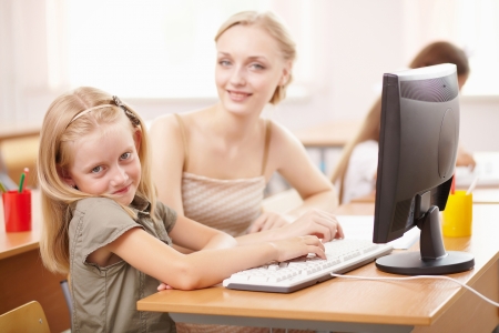 Little girl sitting and studying at school classの写真素材