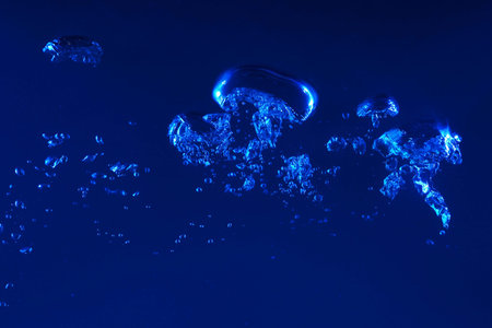 Clean blue water splash on dark blue background