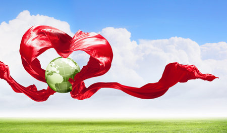 World within the heart symbol on blue sky backgroundの写真素材