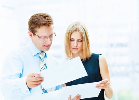 Two young business collegue working together in officeの写真素材