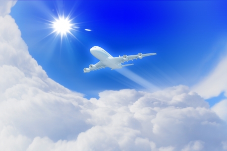 White passenger plane flying in the blue sky with white clouds aroundの写真素材