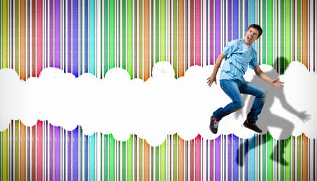 pretty modern slim hip-hop style man jumping dancing on a colour backgroundの写真素材