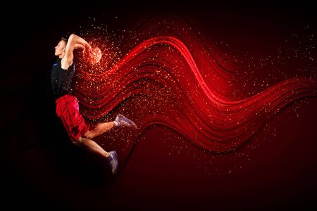 Male basketball player jumping and practicing with a ballの写真素材