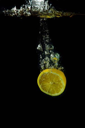 Bright and juicy lemon under water  Fresh and healthy mealの写真素材