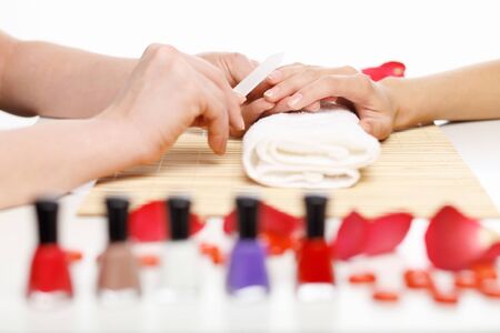 Young woman is getting manicure in a beauty salonの写真素材