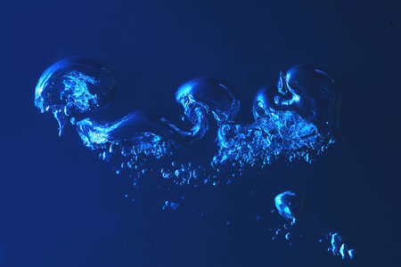 Clean blue water splash on dark blue background