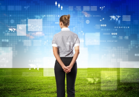 Business person standing against modern virtual technology backgroundの写真素材