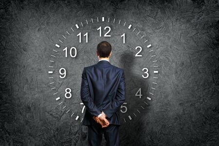Businessman standing and making his choice between timesの写真素材