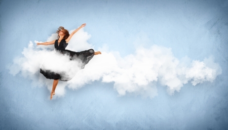 Portrait of a dancing young woman with white cloudy smoke aroundの写真素材