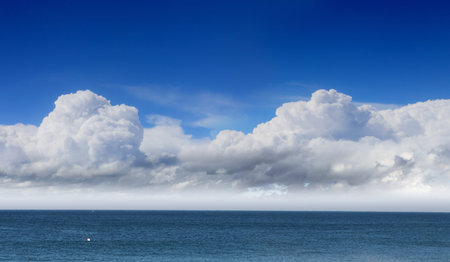bright blue sky with sun shining and some clouds